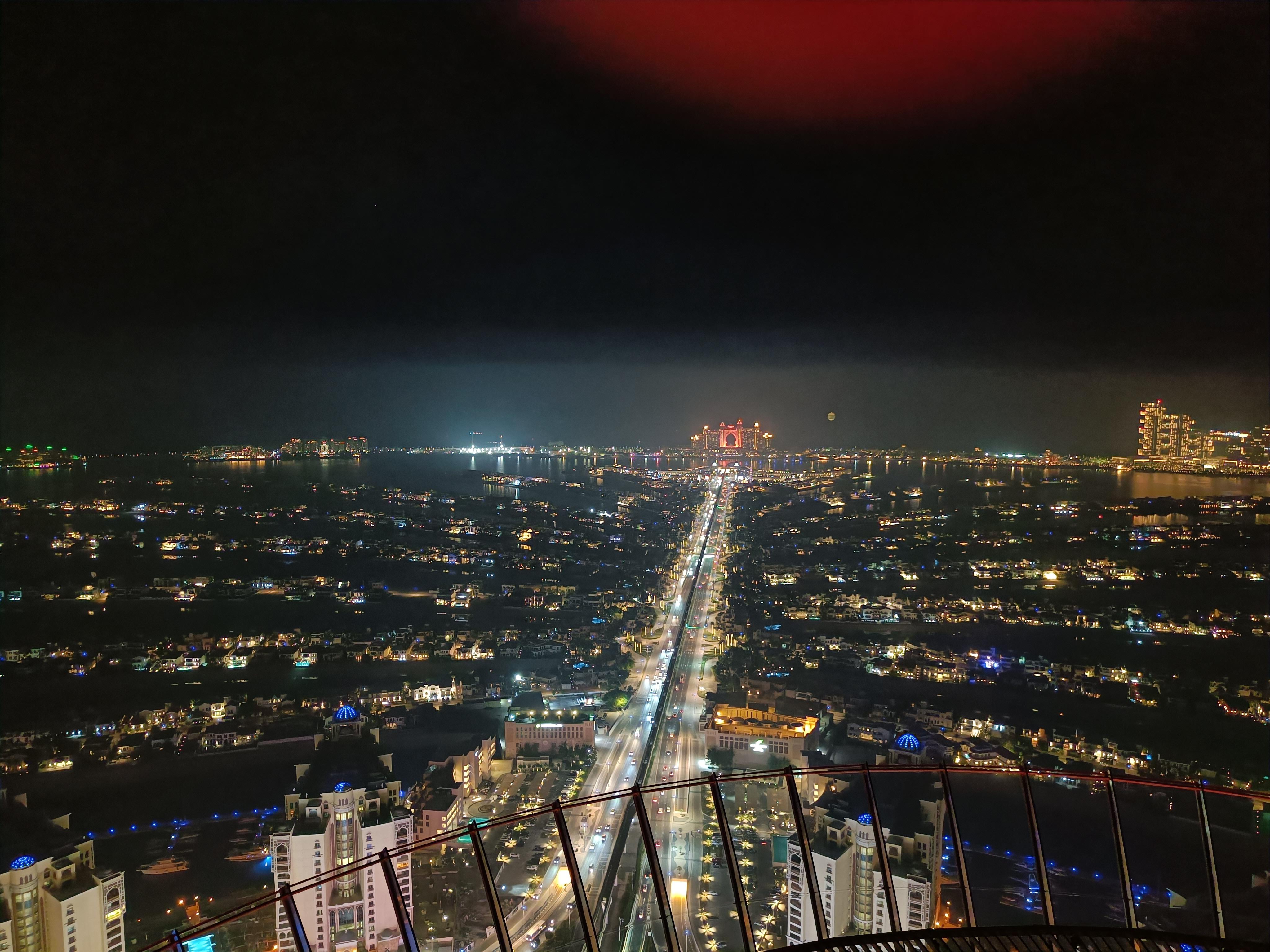 View at the Palm skyline vista with illuminated buildings - panoramic night view of Dubai's iconic Palm Island
